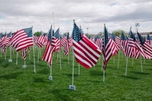 This picture shows amerian flags on a green field, and the blog talks about Consular Processing for Green Card